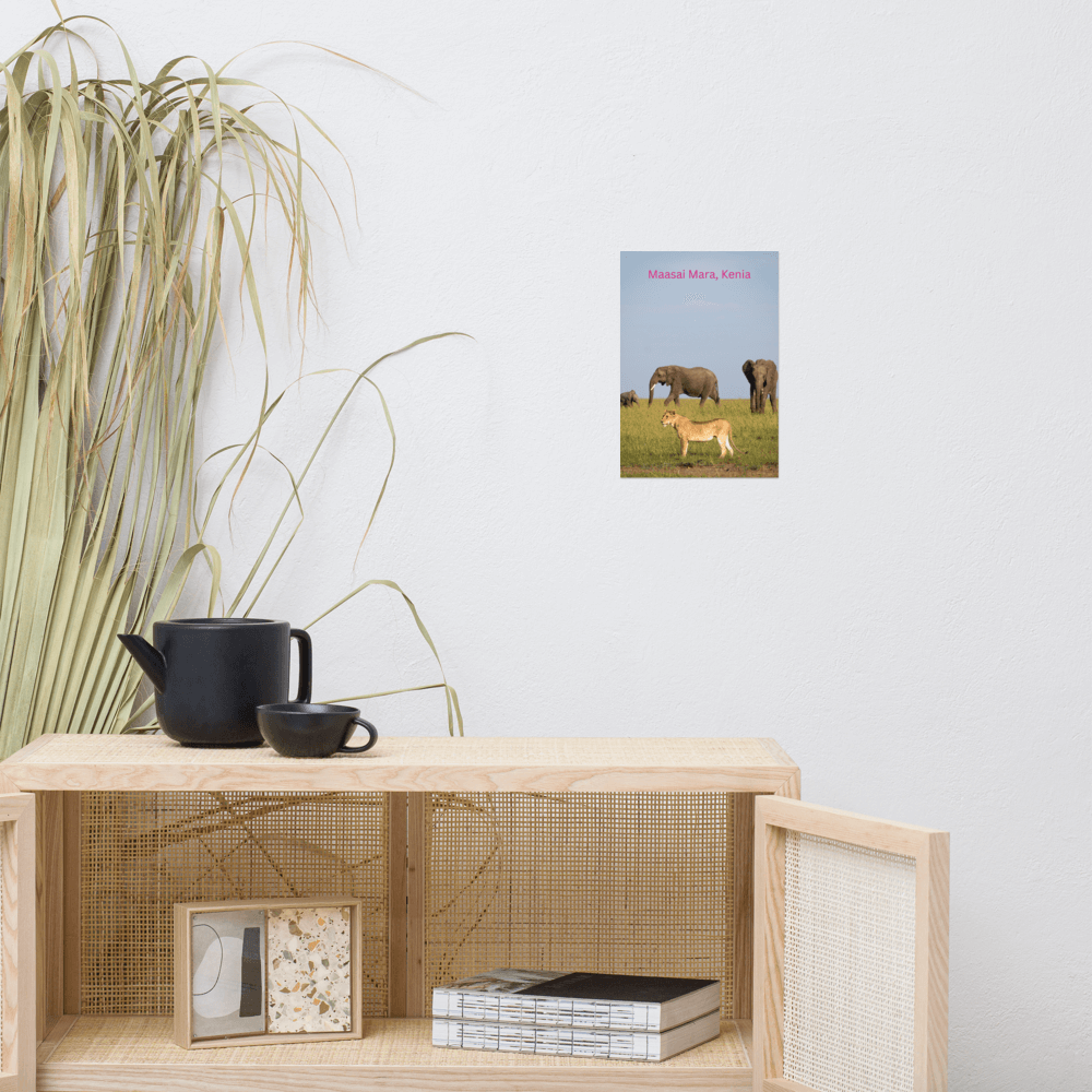 Maasai Mara Kenya poster on matte paper displayed on a shelf with black teapot and decorative plants.