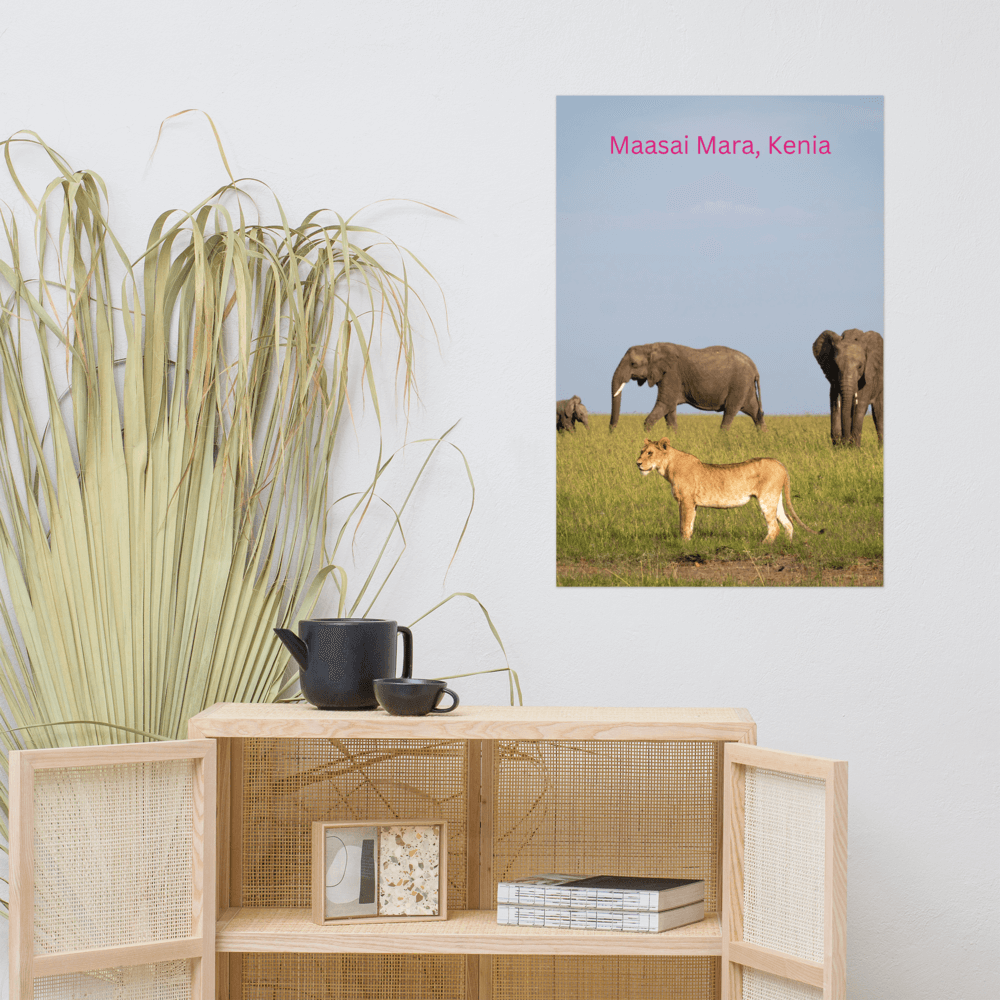 Maasai Mara, Kenya poster with animals on green grass displayed in a modern room setting with black teapot and books.